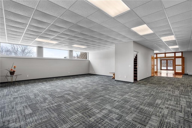 basement featuring dark colored carpet