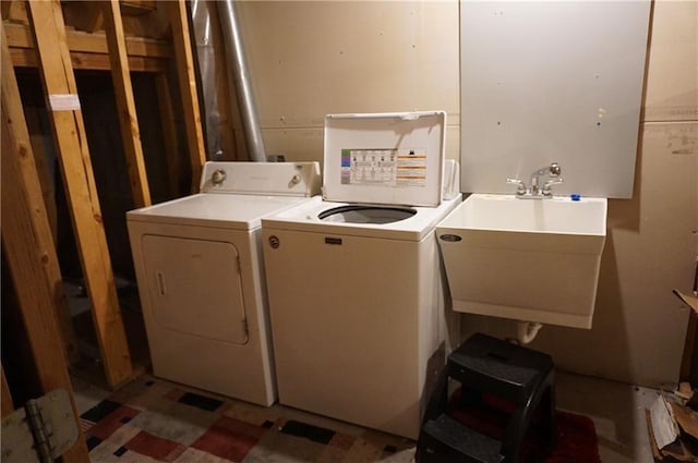 washroom featuring washing machine and clothes dryer and sink