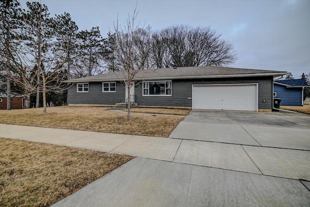 single story home featuring a garage and a front lawn