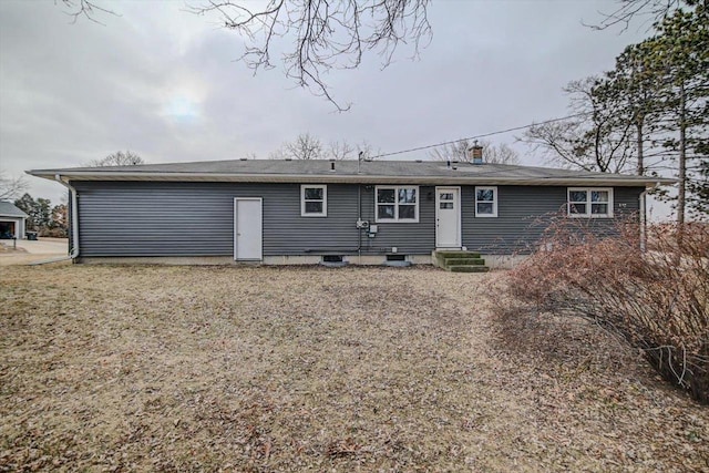 rear view of house with a yard