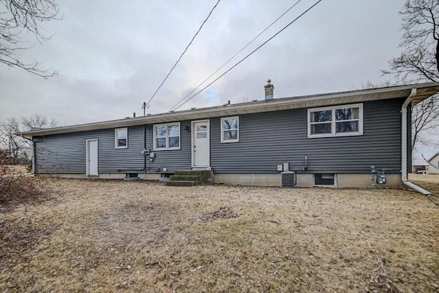 rear view of property with a lawn