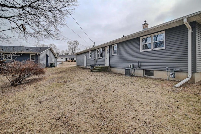 back of house with central AC unit