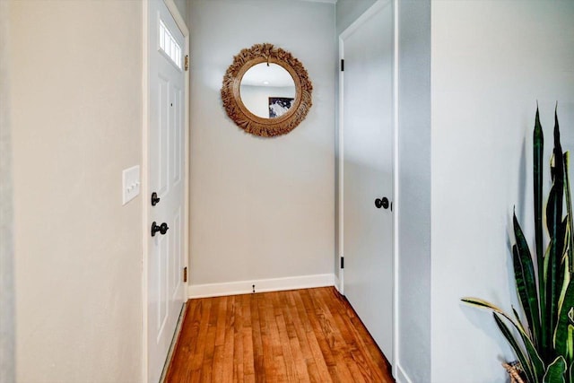 hallway with light hardwood / wood-style floors