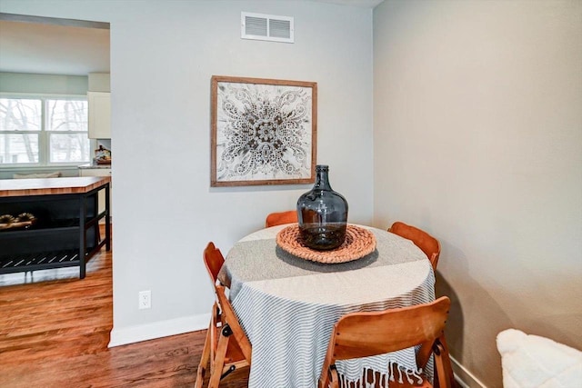 dining area with hardwood / wood-style flooring