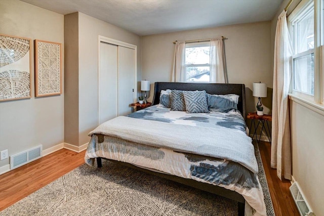 bedroom with wood-type flooring and a closet