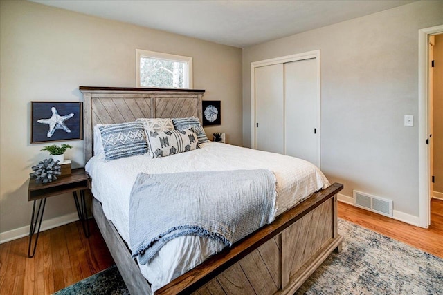 bedroom with wood-type flooring and a closet