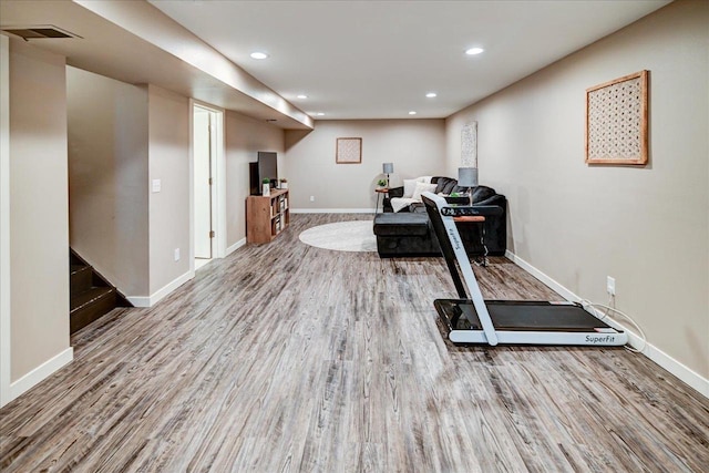 workout area with light hardwood / wood-style floors