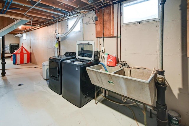 washroom with separate washer and dryer and sink