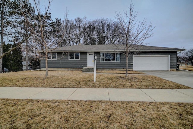 single story home featuring a garage and a front lawn