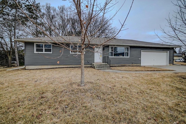 ranch-style home with a garage and a front lawn