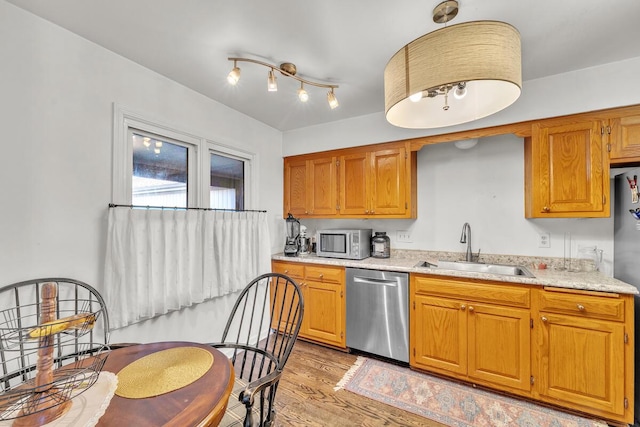 kitchen featuring sink, light hardwood / wood-style flooring, and appliances with stainless steel finishes