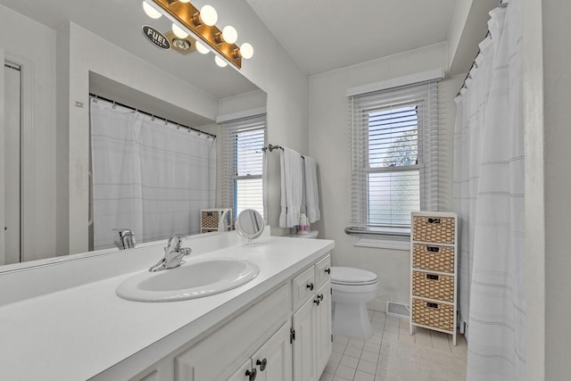 bathroom with vanity, tile patterned flooring, and toilet