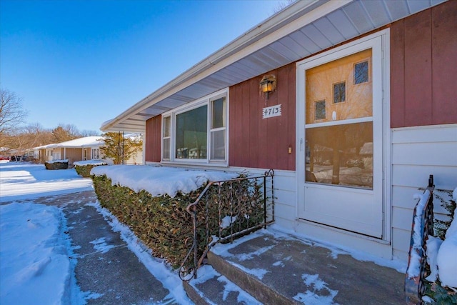 view of snow covered property entrance