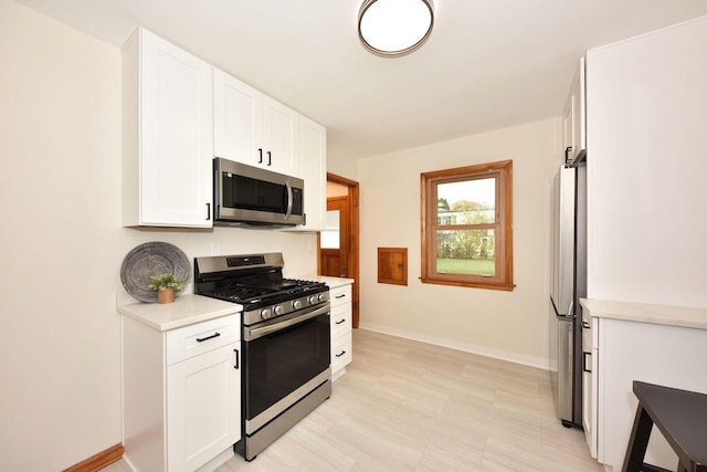 kitchen with appliances with stainless steel finishes and white cabinets