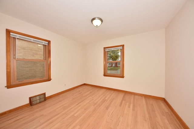 unfurnished room with light wood-type flooring