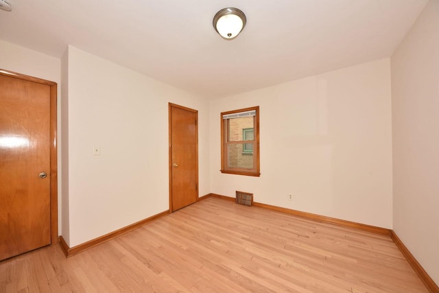 spare room with light hardwood / wood-style flooring