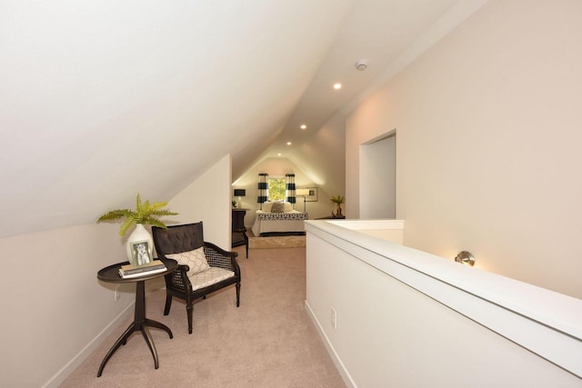 sitting room featuring light colored carpet and lofted ceiling