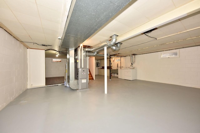 basement with washer and dryer and heating unit