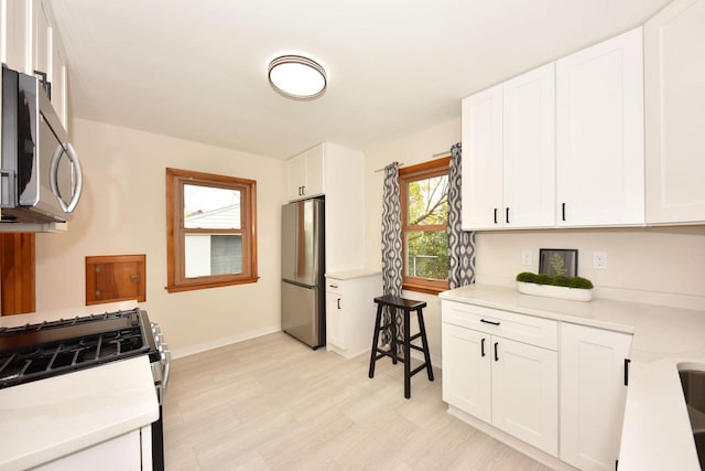 kitchen featuring stainless steel appliances and white cabinets