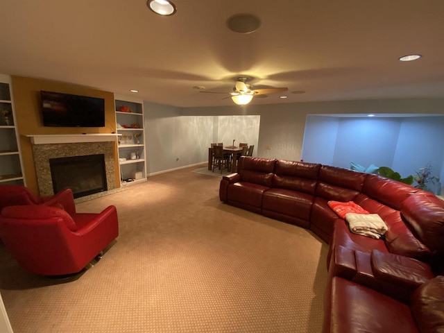 carpeted living room with built in features and ceiling fan