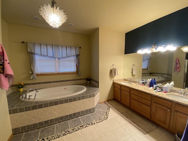 bathroom with a relaxing tiled tub, vanity, tile patterned floors, and an inviting chandelier