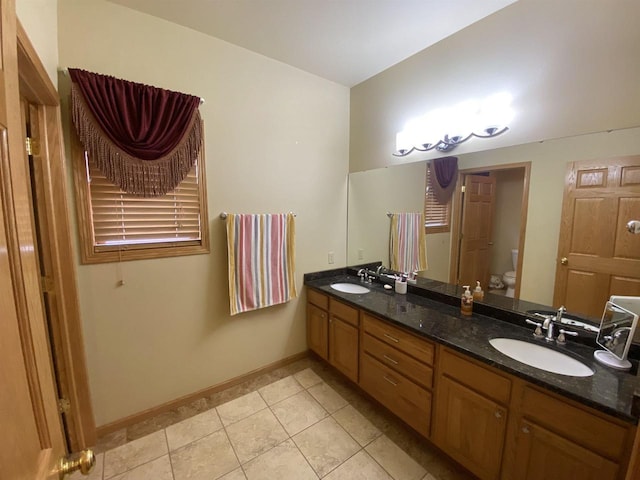 bathroom featuring vanity, tile patterned floors, and toilet