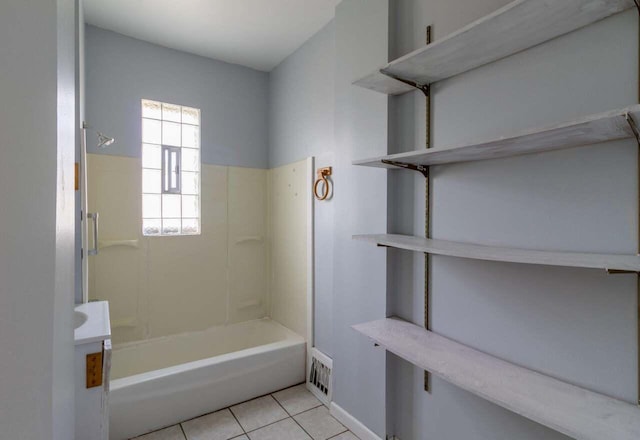 bathroom with tile patterned flooring and bathing tub / shower combination