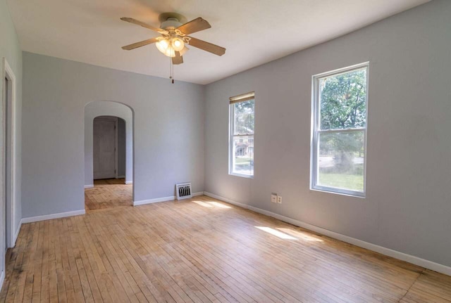 empty room with ceiling fan and light wood-type flooring