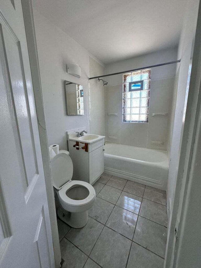 full bathroom featuring tiled shower / bath, vanity, toilet, and tile patterned flooring