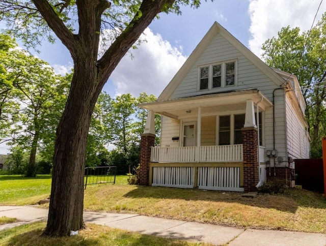 view of front of home with a front yard and a porch