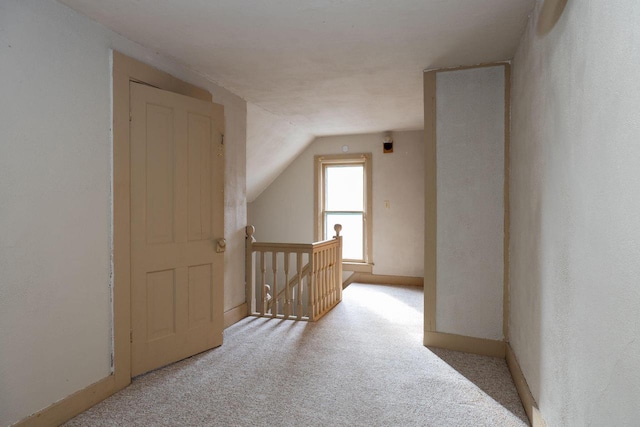 bonus room featuring light colored carpet and lofted ceiling