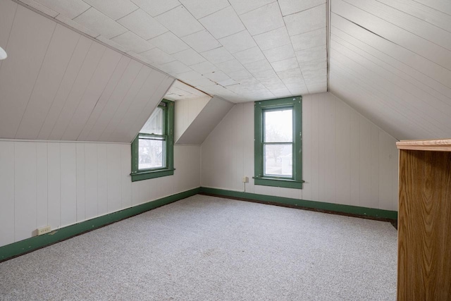 bonus room featuring vaulted ceiling and carpet flooring