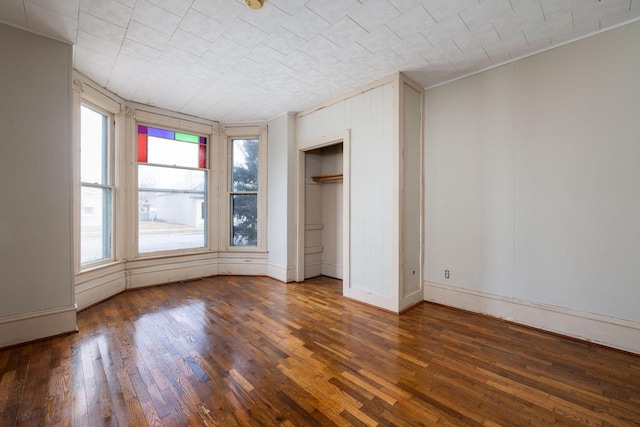 unfurnished bedroom featuring dark hardwood / wood-style flooring