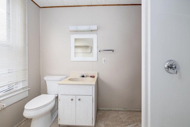 bathroom featuring ornamental molding, toilet, and vanity