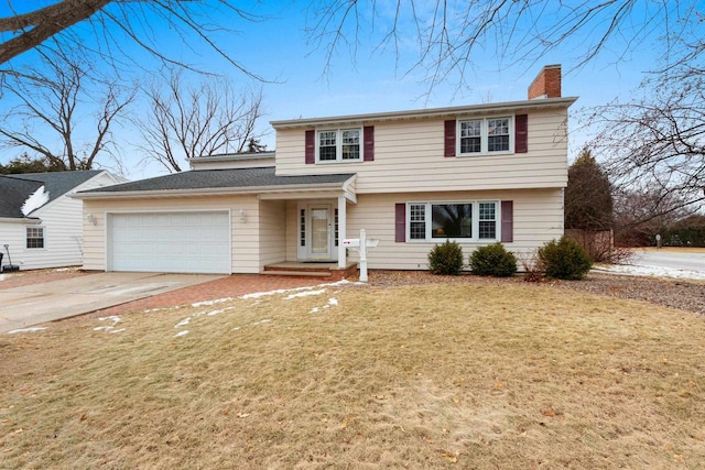 view of front of house with a garage and a front yard