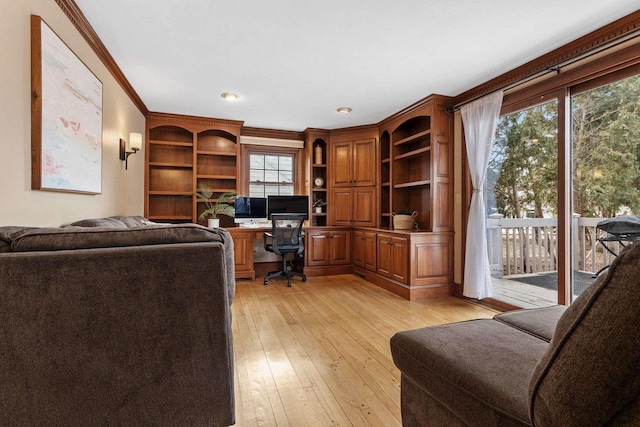 office space with crown molding and light wood-type flooring