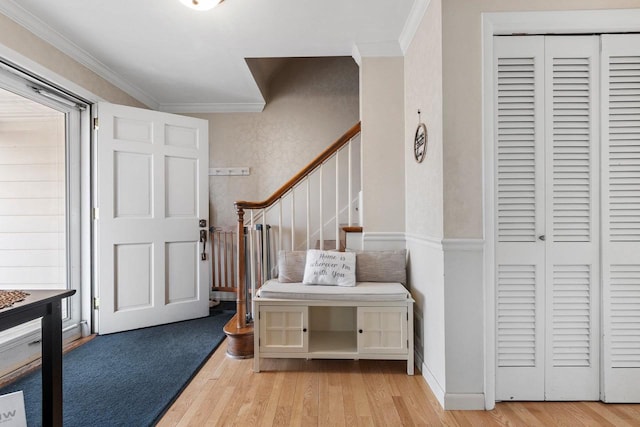 foyer featuring crown molding and light wood-type flooring