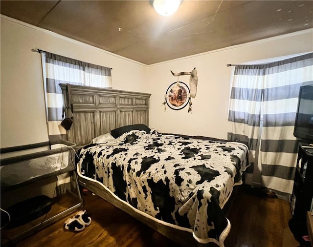 bedroom with dark hardwood / wood-style floors