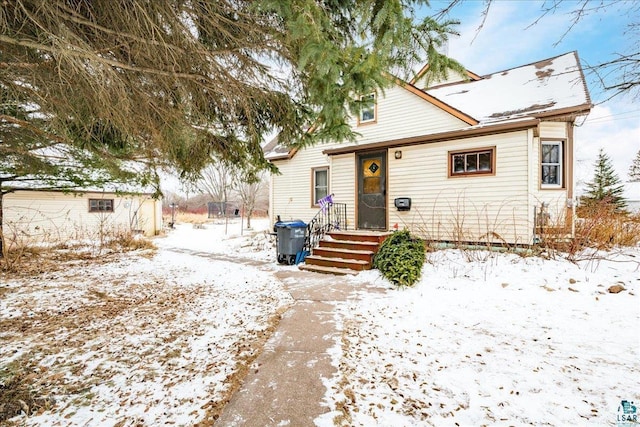 bungalow featuring a storage shed