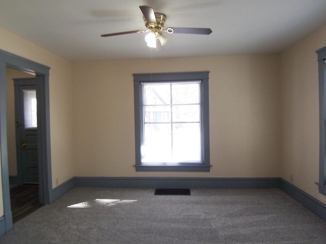 carpeted empty room featuring ceiling fan