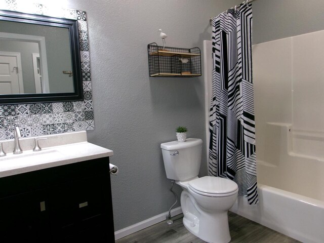 full bathroom featuring vanity, wood-type flooring, shower / bath combo, and toilet