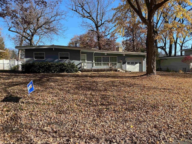 ranch-style house with a garage and covered porch