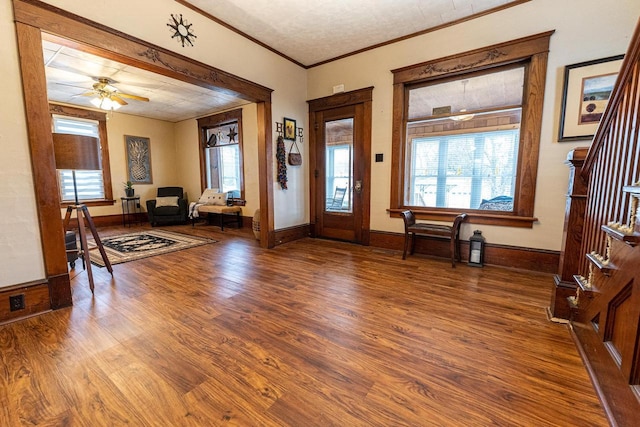 entrance foyer with crown molding, hardwood / wood-style flooring, and ceiling fan