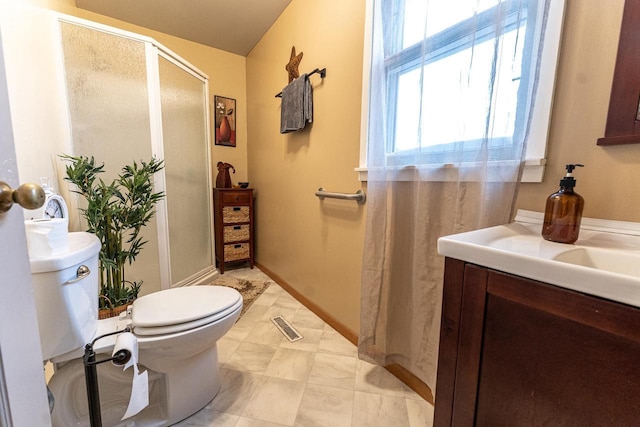 bathroom featuring vanity, an enclosed shower, and toilet