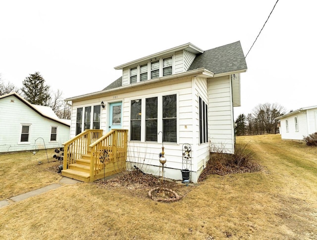 rear view of property with a yard