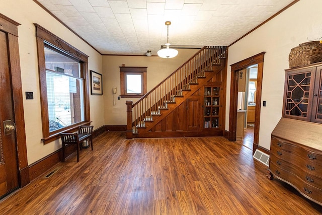 interior space featuring ornamental molding and dark hardwood / wood-style floors