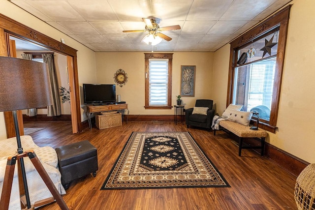 living room featuring dark hardwood / wood-style floors and ceiling fan