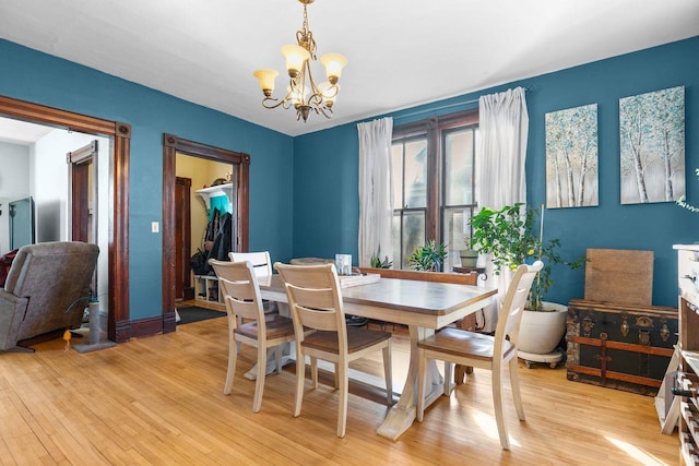 dining area with an inviting chandelier and light wood-type flooring