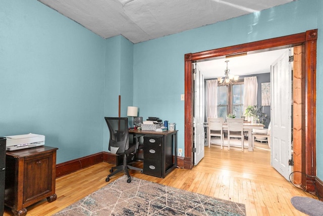 office with a chandelier and light wood-type flooring