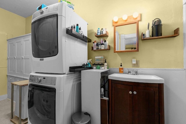 clothes washing area with sink and stacked washer and clothes dryer